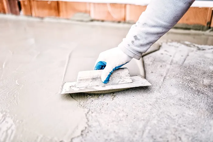 Construction Worker Finishing Concrete